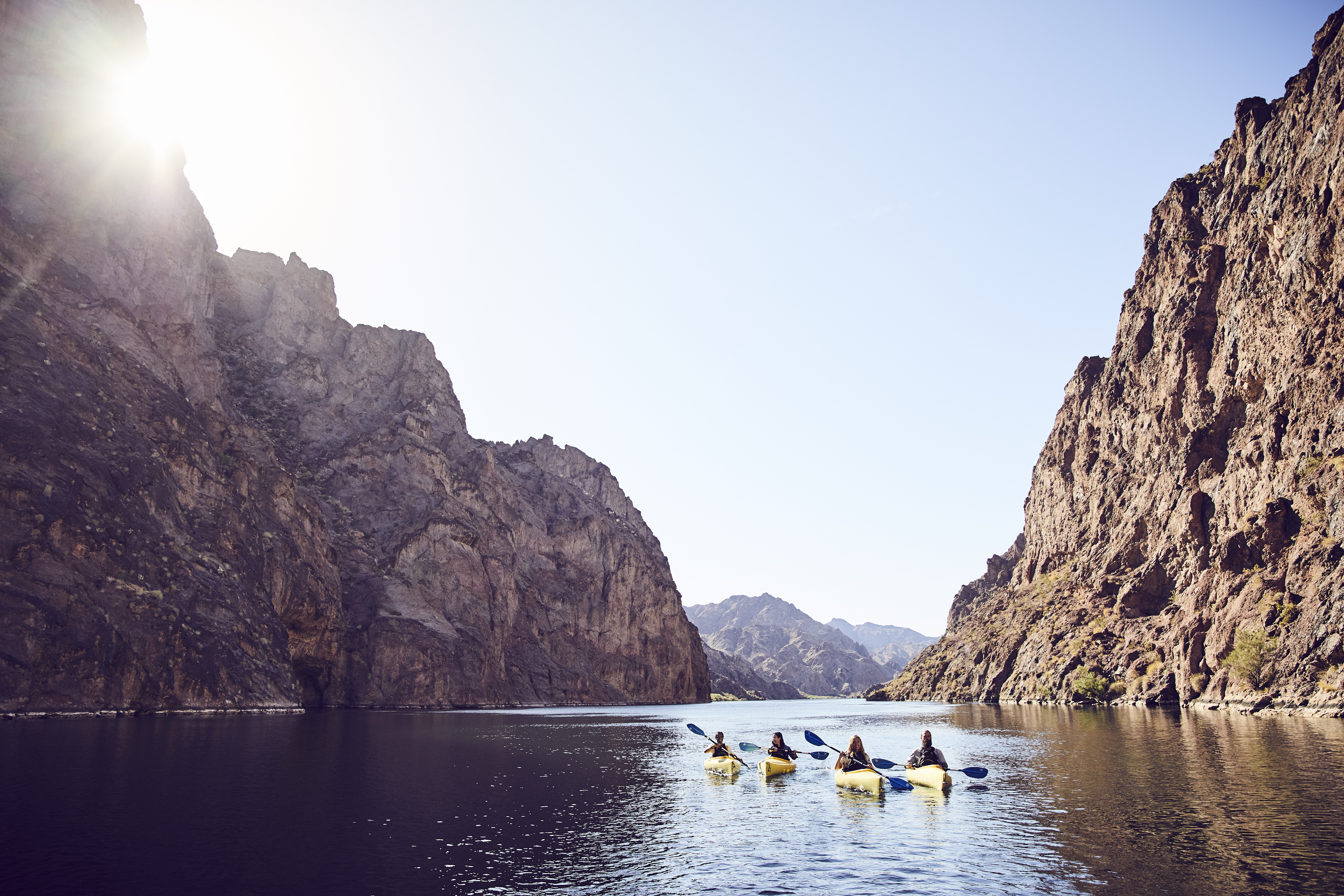 Kayakers float between the high canyon walls of the Black Canyon Water Trail.