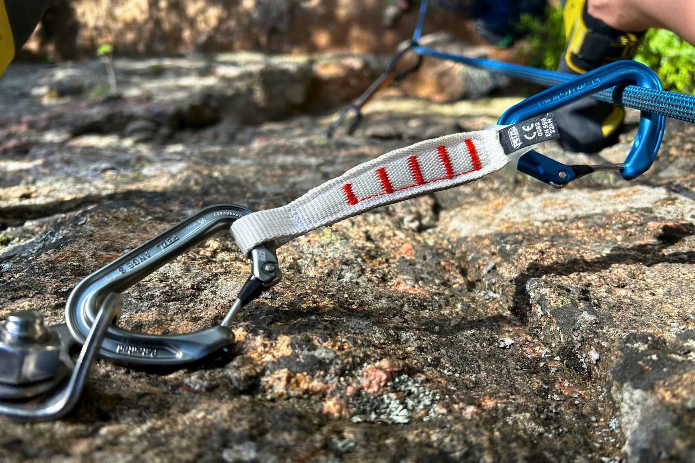 A climber using a Petzl Ange Finesse quickdraw on a route.
