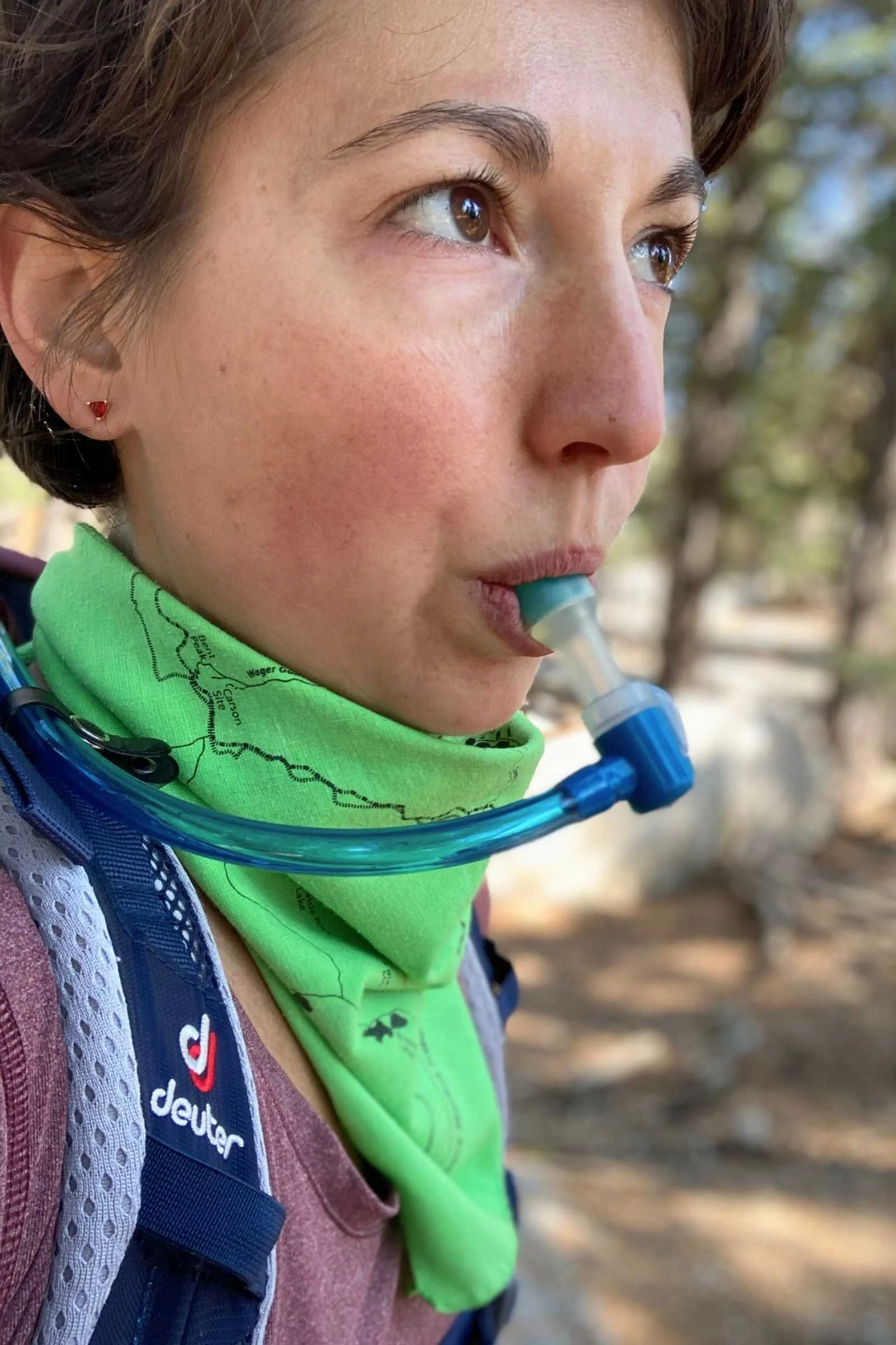 A close-up of a hydration bladder being inserted into the internal sleeve of a Deuter hiking daypack.