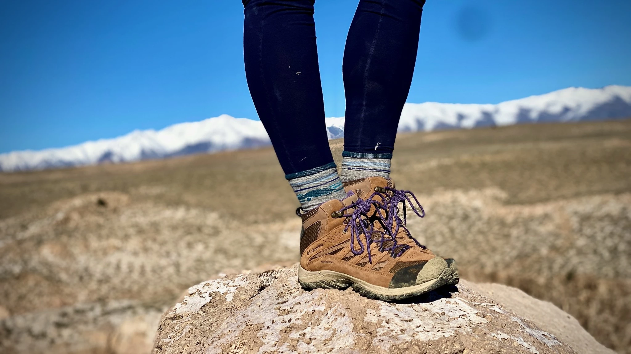 Side profile of a high-cut hiking boot emphasizing the ankle cuff and sturdy leather construction.