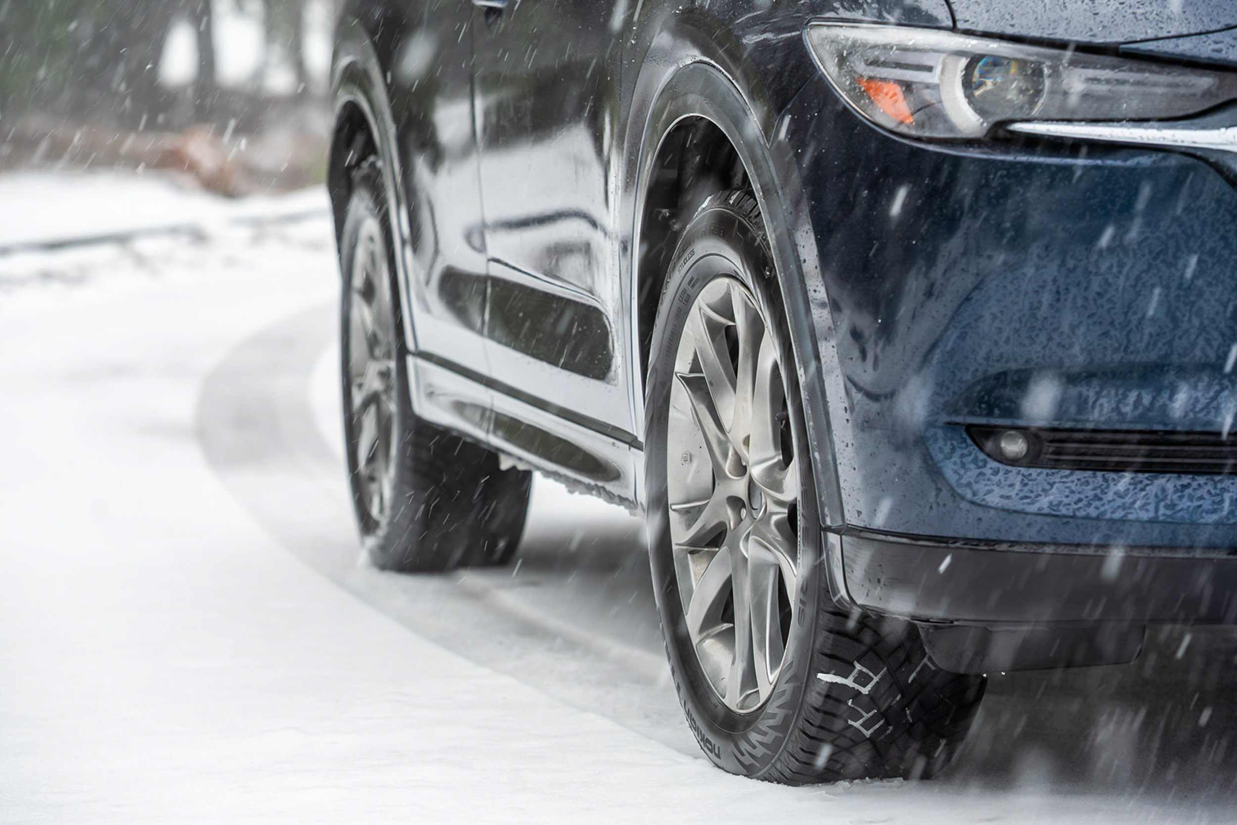 Detailed surface shot of the rubber compound and tread wear area of a winter tire.
