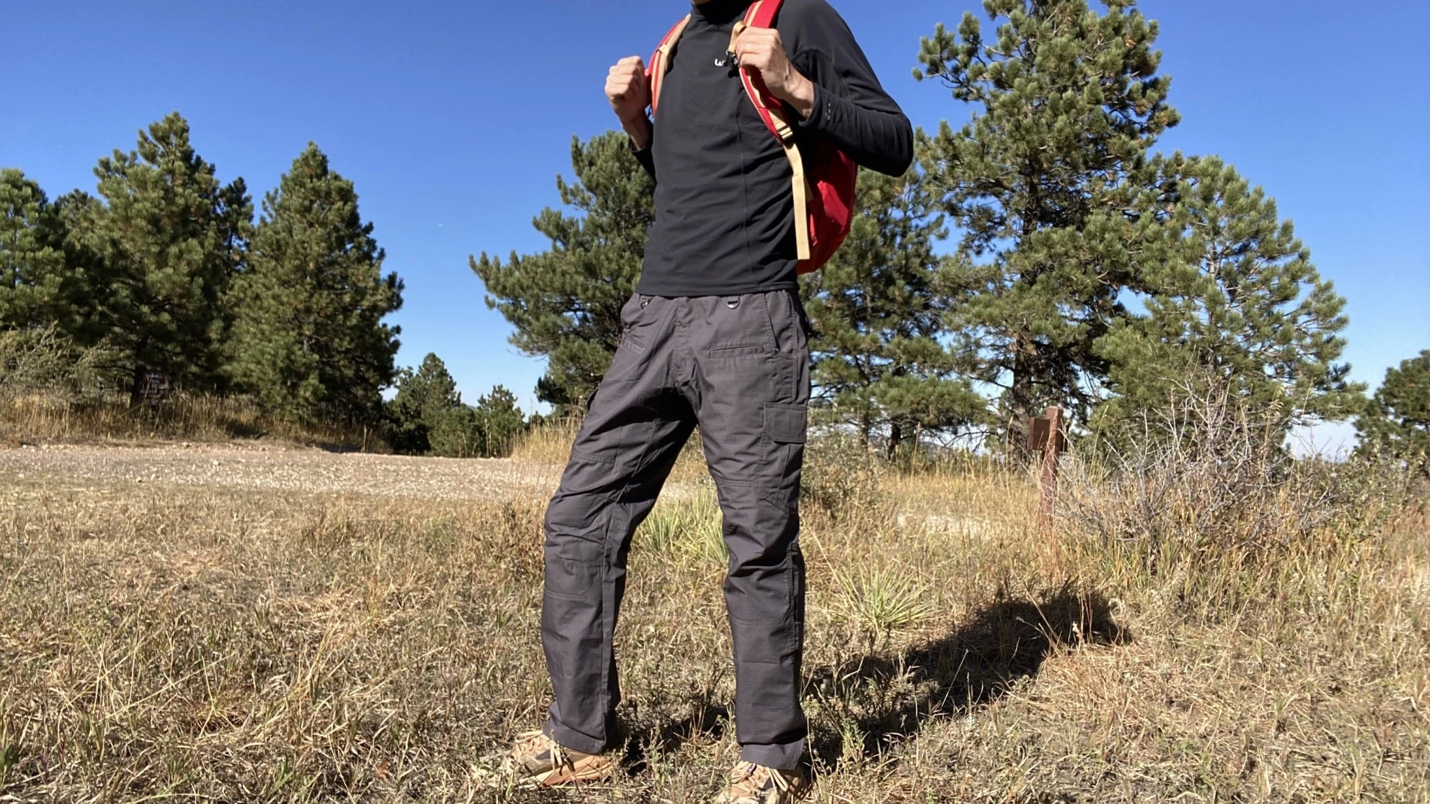A selection of traditional hiking pants showing different pocket layouts and technical features.