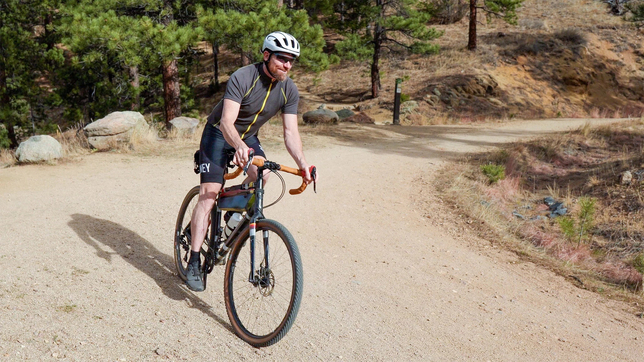A cyclist wearing Roka SR-1X wraparound glasses looking over their shoulder.