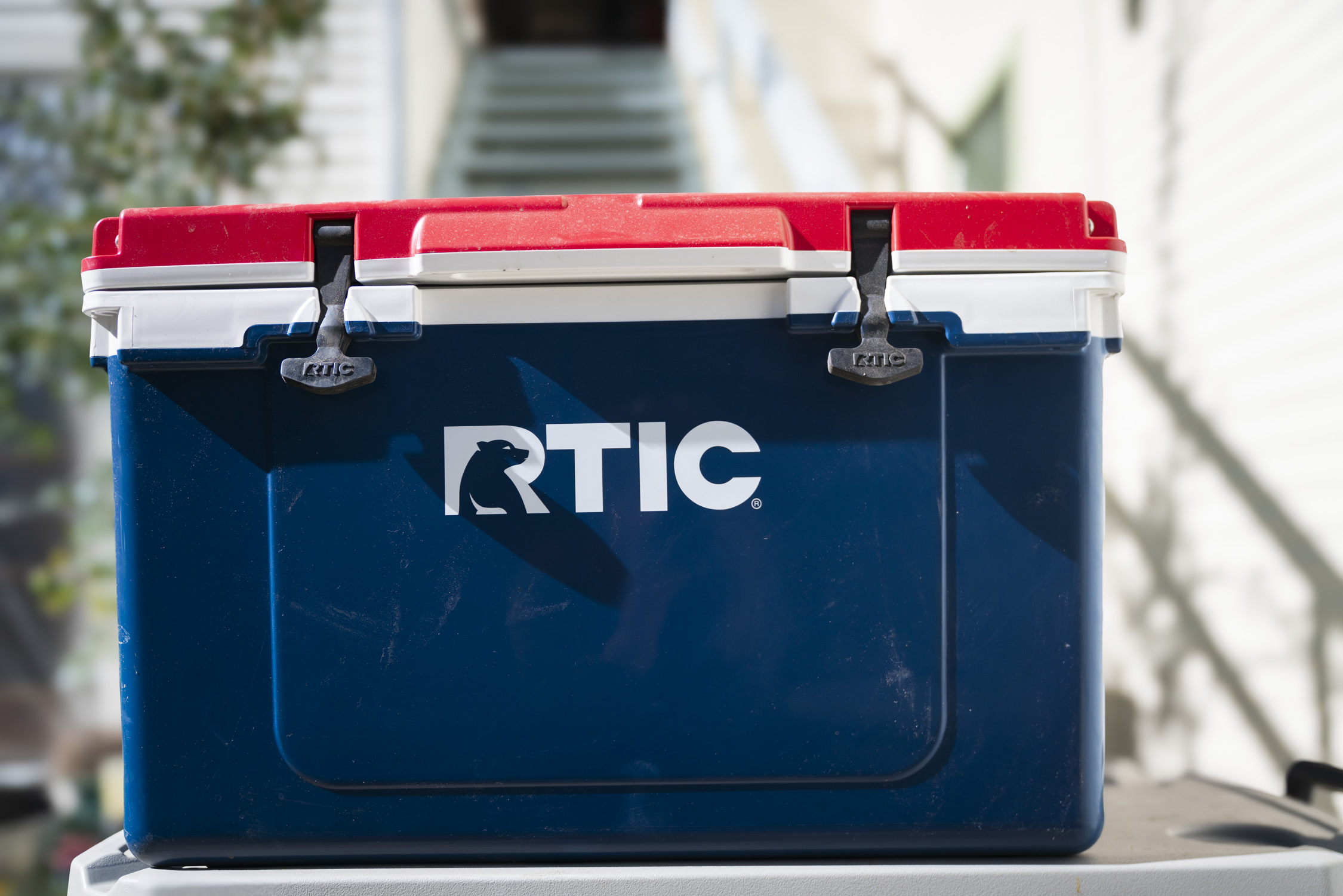 The RTIC Ultra-Light Hard Cooler sitting on a rocky outdoor surface.