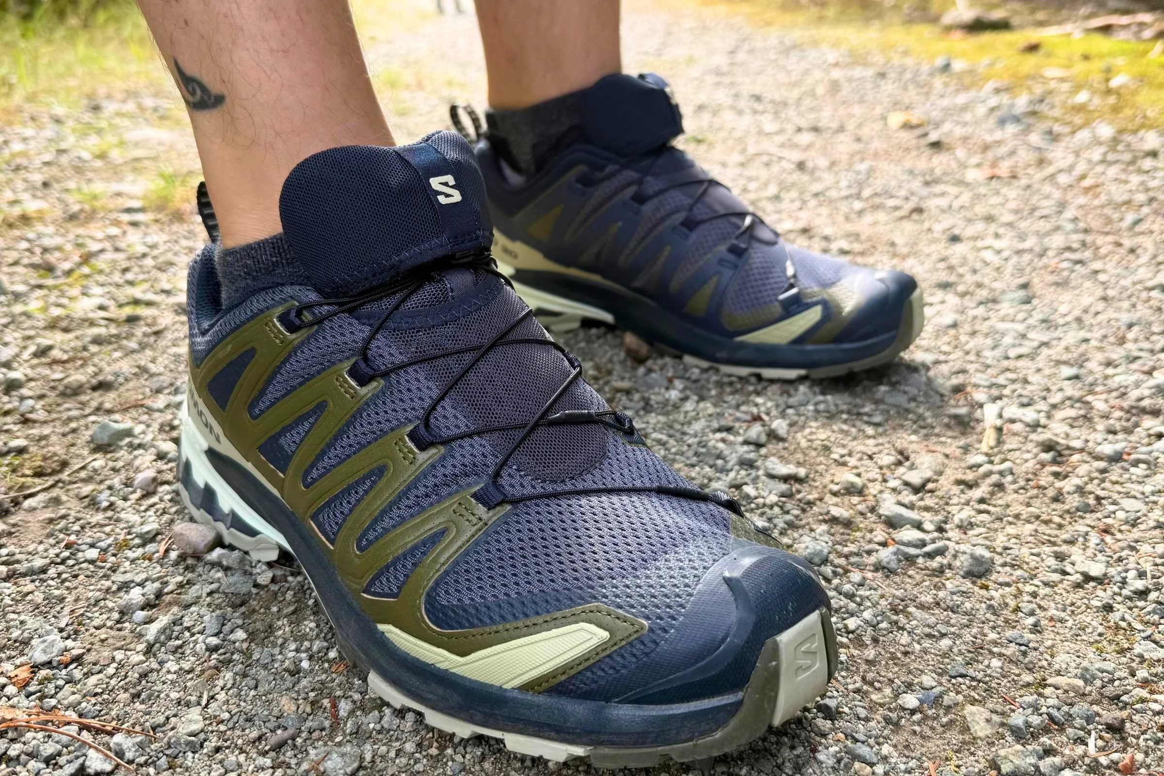 Salomon XA Pro 3D V9 shoe resting on a rocky trail path.