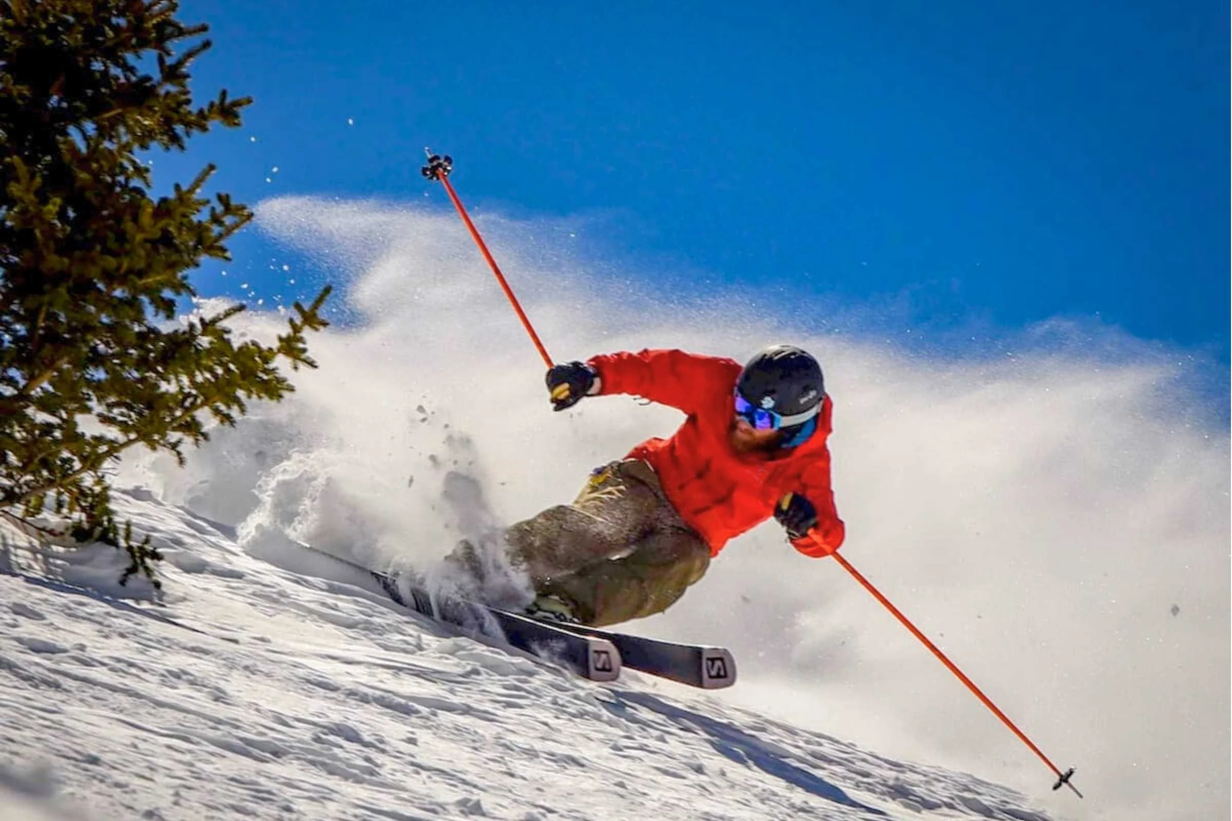 A close-up portrait of a skier emphasizing the importance of head protection.