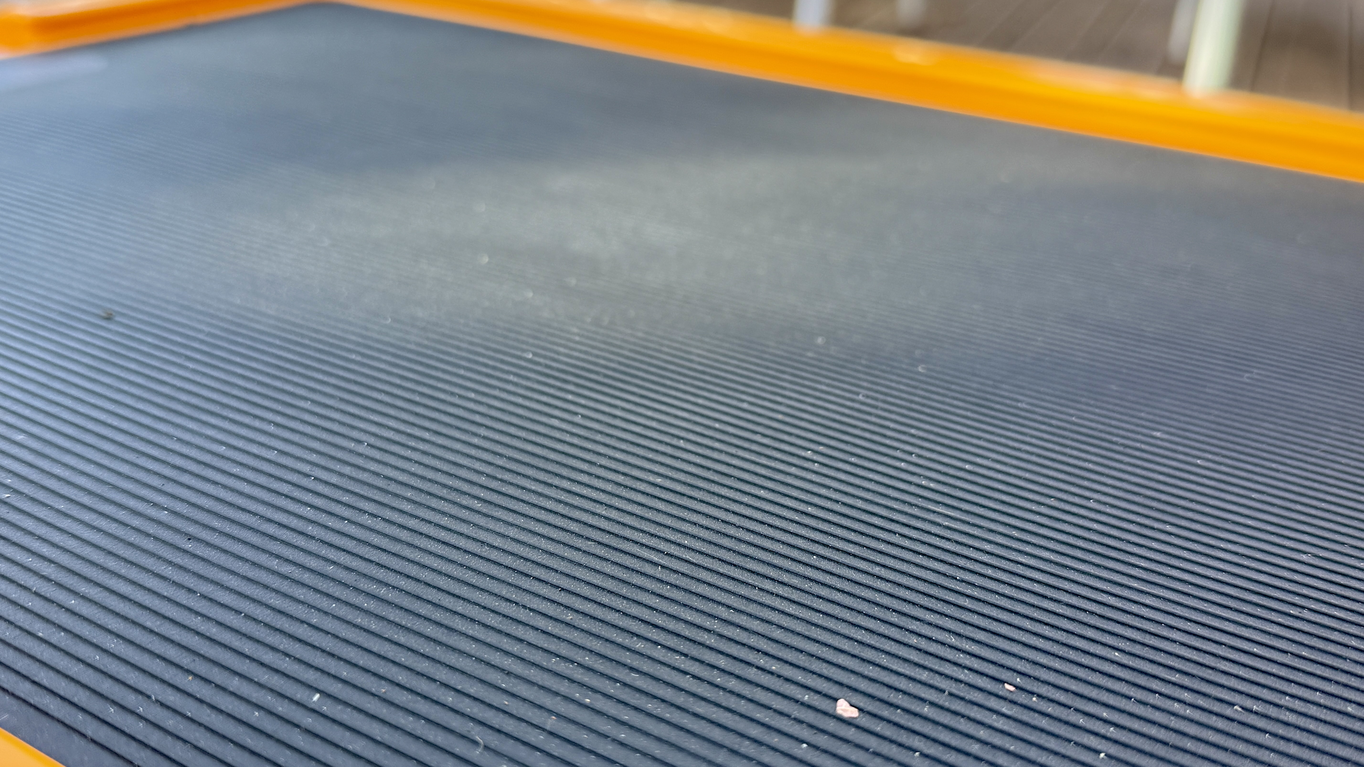 A close-up of gear stacked securely on the rubberized lid of the Dometic Recon cooler.