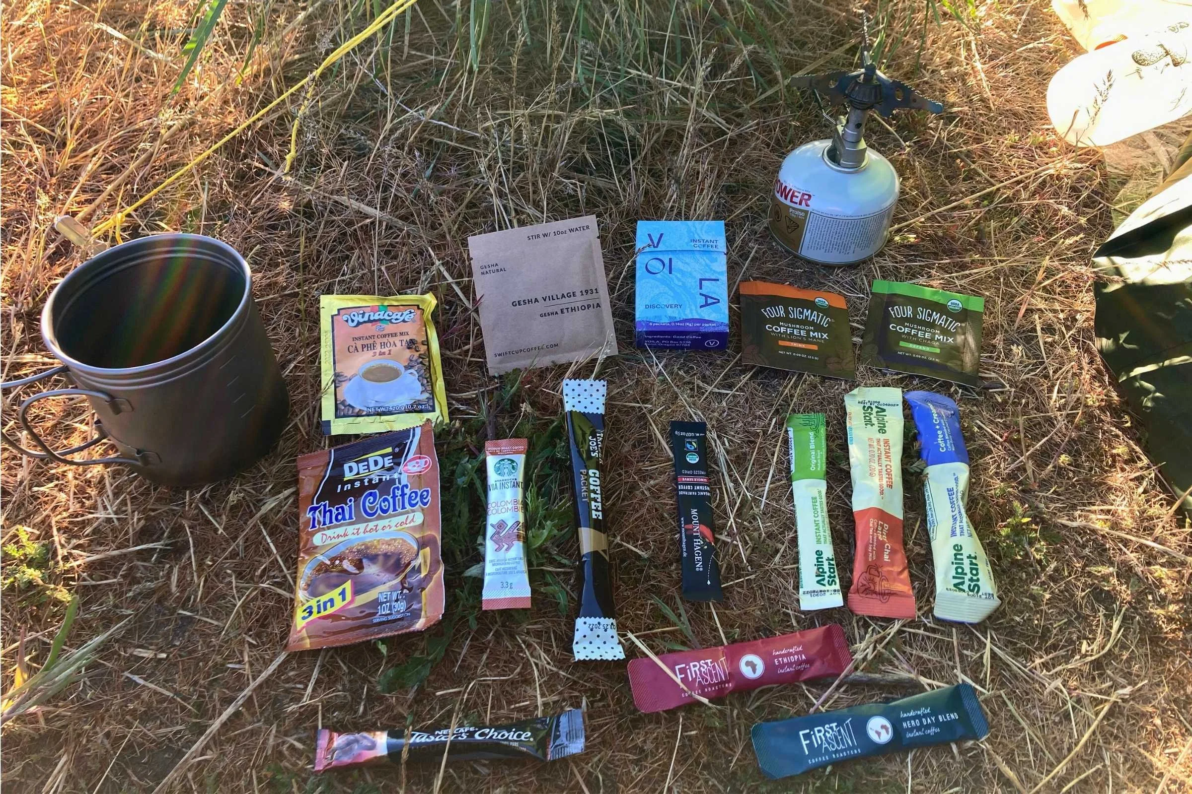 A wide assortment of various instant coffee packets and sachets laid out for comparison.