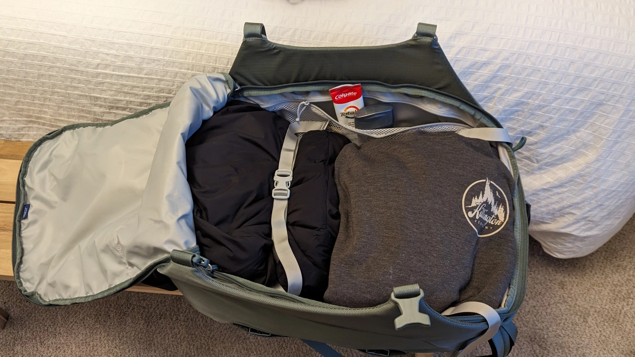 The open interior of a travel backpack showing internal compression straps.
