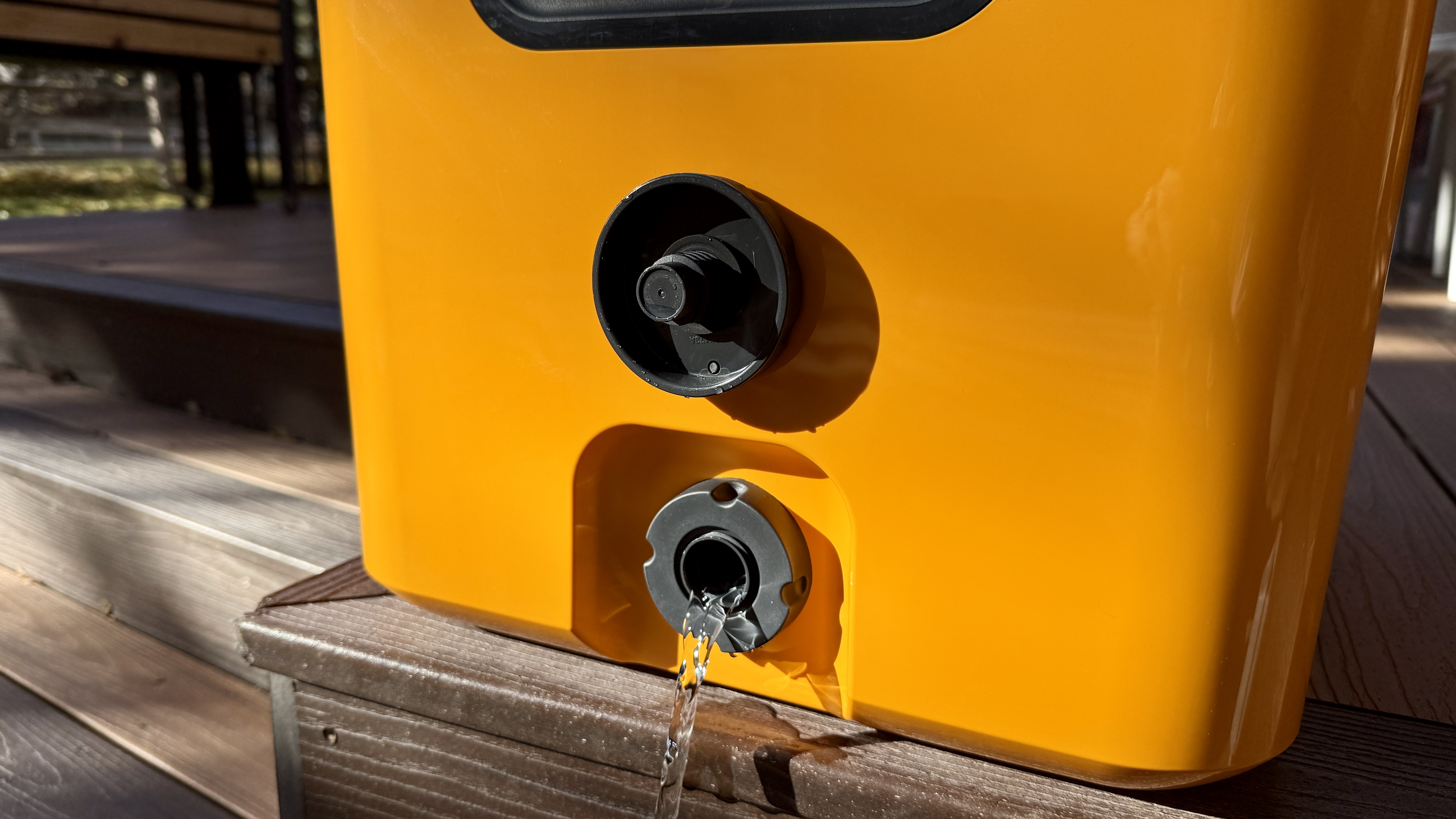 Detail shot of the drain plug magnetically attached to the side wall of the cooler.