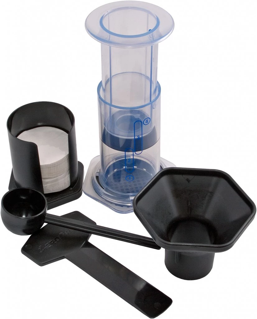 An AeroPress coffee maker being used to brew coffee at a campsite.