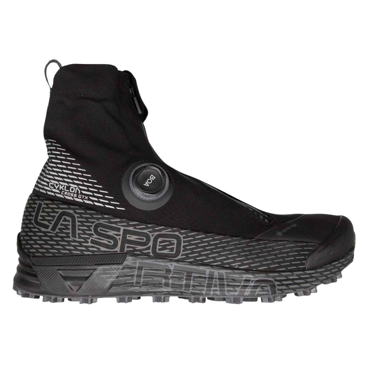 A runner stepping through deep snow with the integrated waterproof gaiter fully zipped.