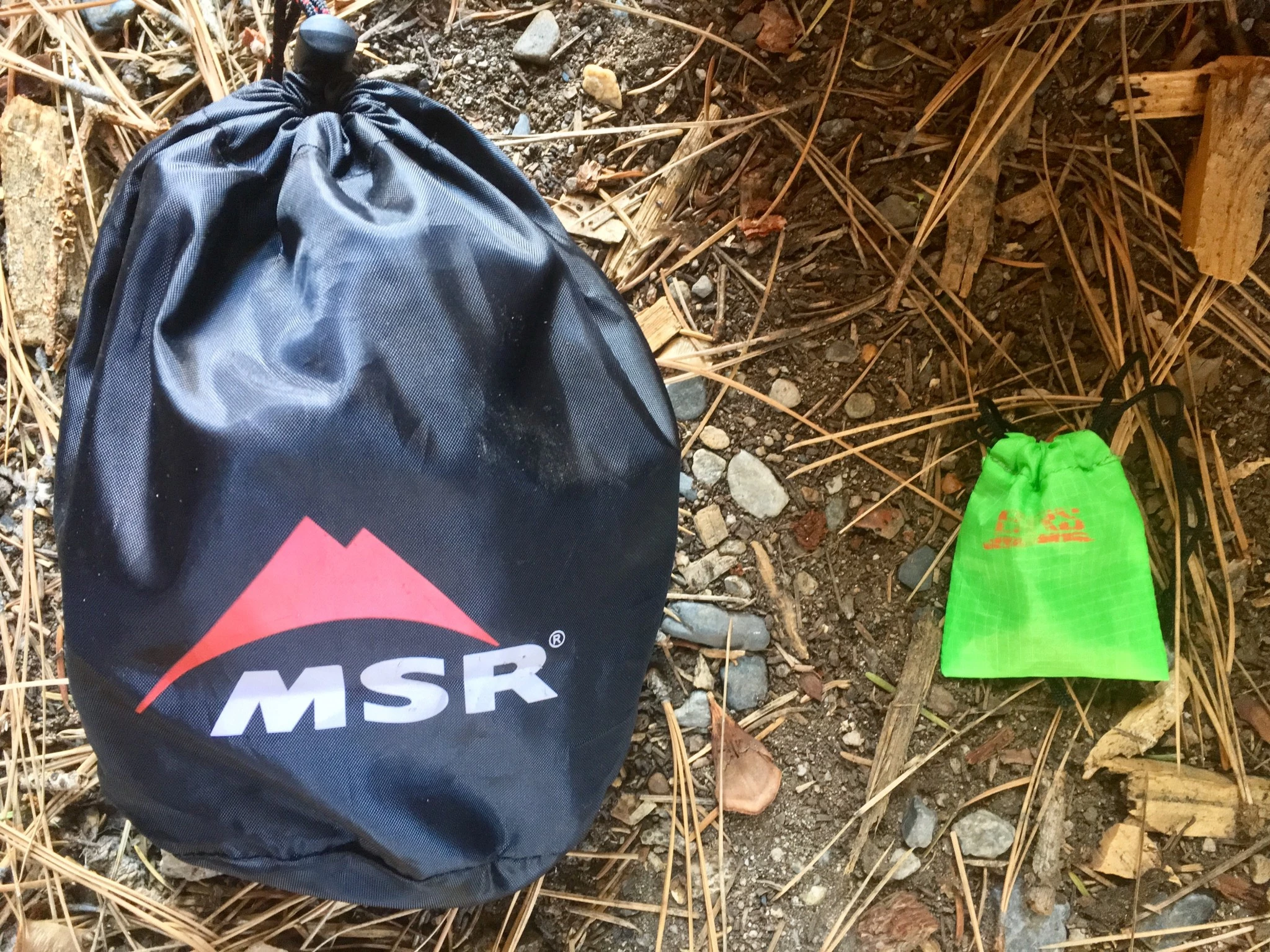 Side-by-side comparison of a larger liquid fuel MSR Universal stove and a tiny BRS canister burner.