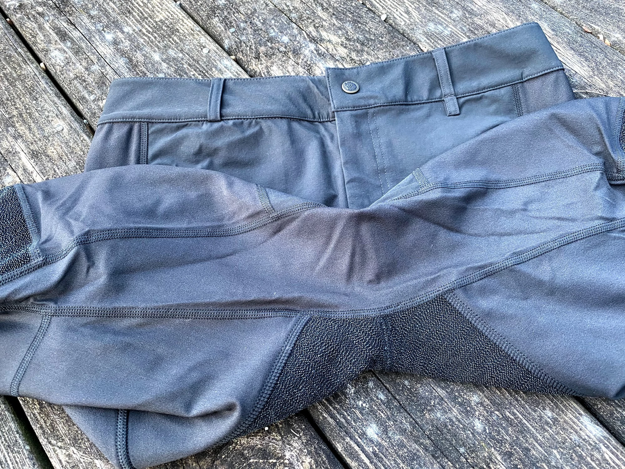A detailed view of the gusseted crotch construction in technical hiking trousers.
