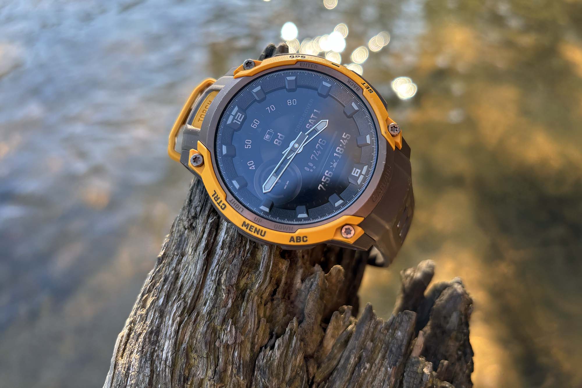 The Garmin Instinct Crossover AMOLED on a wrist during a sunny outdoor excursion.