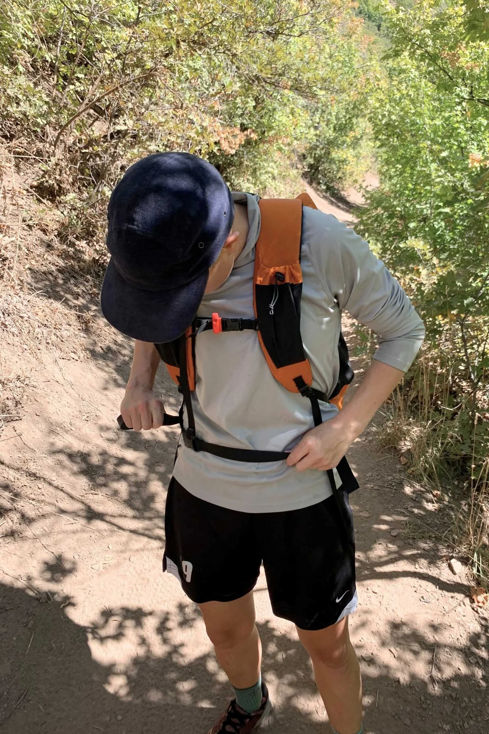 A detailed side-view shot of a daypack's padded and mesh-lined shoulder straps being worn.