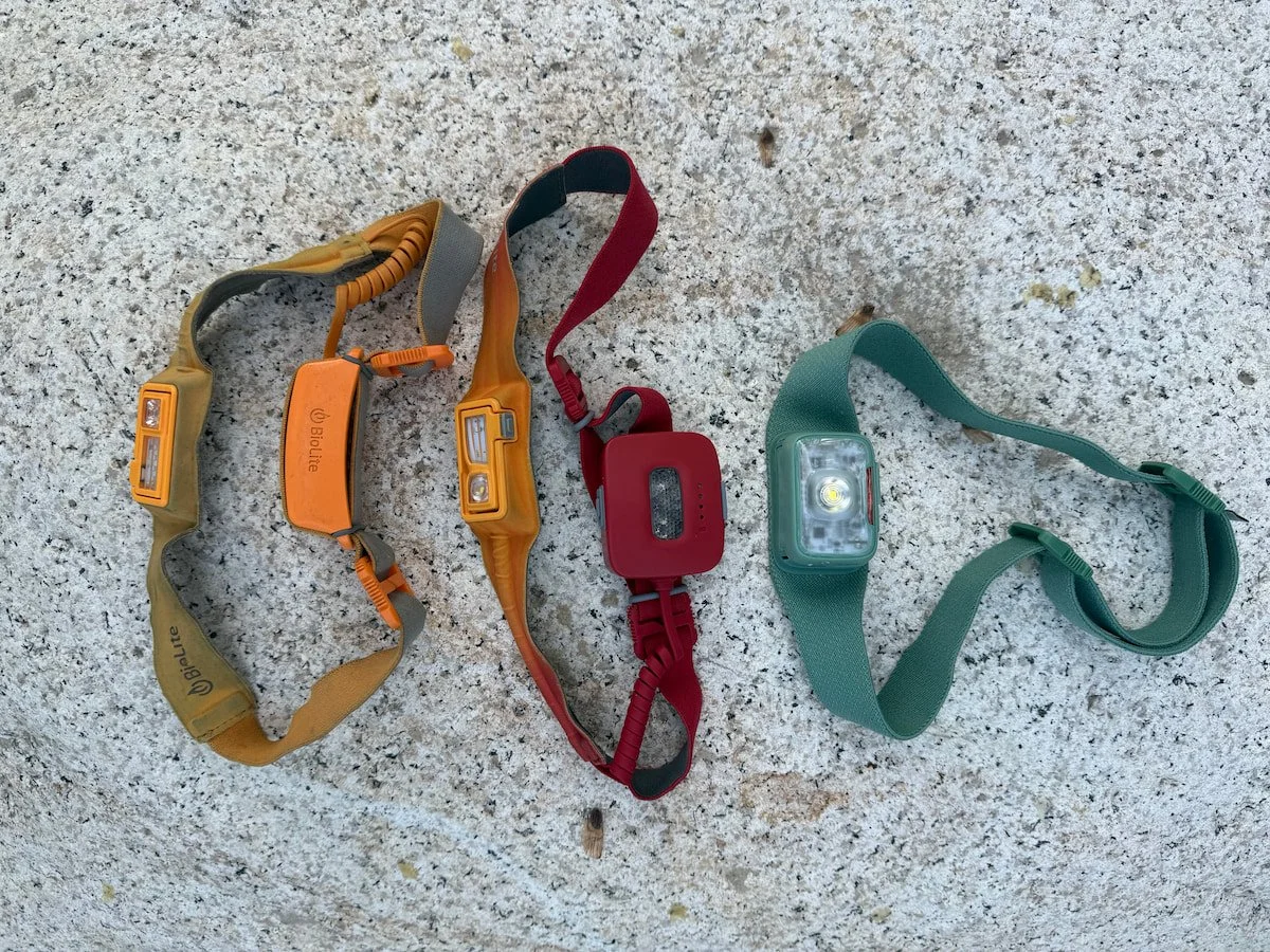A side-by-side comparison of the BioLite 330, Dash 450, and Range 400 headlamps showing battery positions.