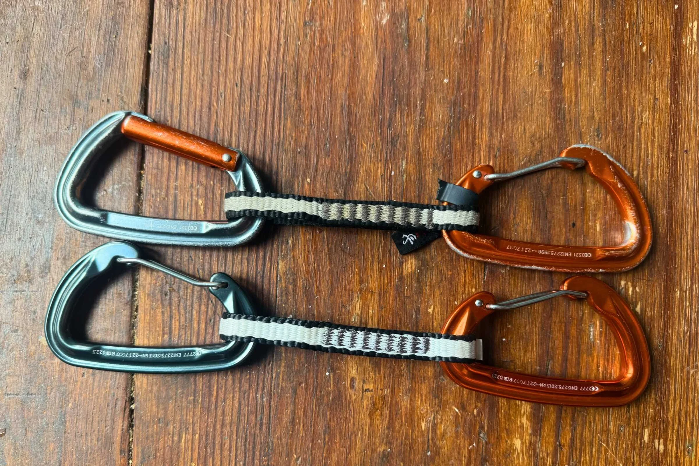 Comparison of a broken, weathered rubber carabiner keeper on an old quickdraw versus a new one.
