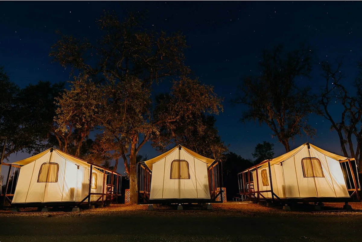 A large safari-style safari tent at Wildhaven Sonoma set against a scenic landscape.