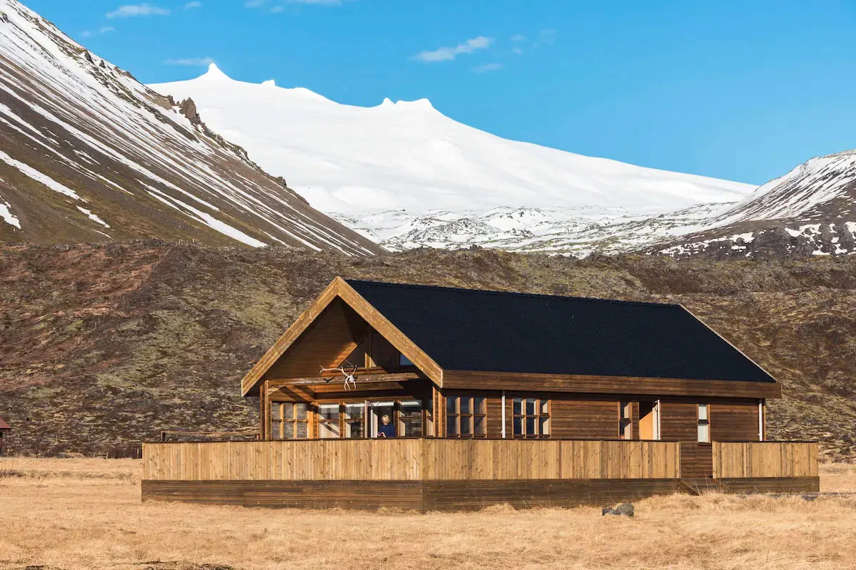 Modern dark-clad cabin with large windows situated in the Snæfellsnesjökull National Park region.