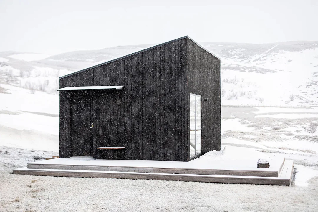 Minimalist interior of a modern cabin with wooden accents and a clean Scandinavian design.