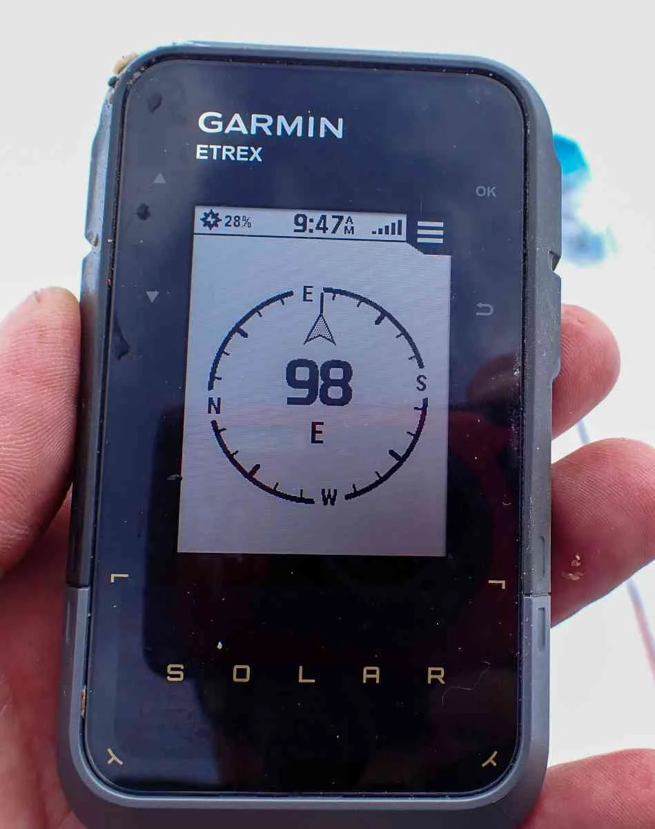 The monochrome digital magnetic compass screen on a Garmin eTrex Solar handheld.