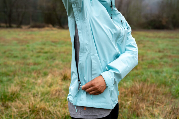 Close-up of a rain jacket's pit zip and underarm ventilation opening.