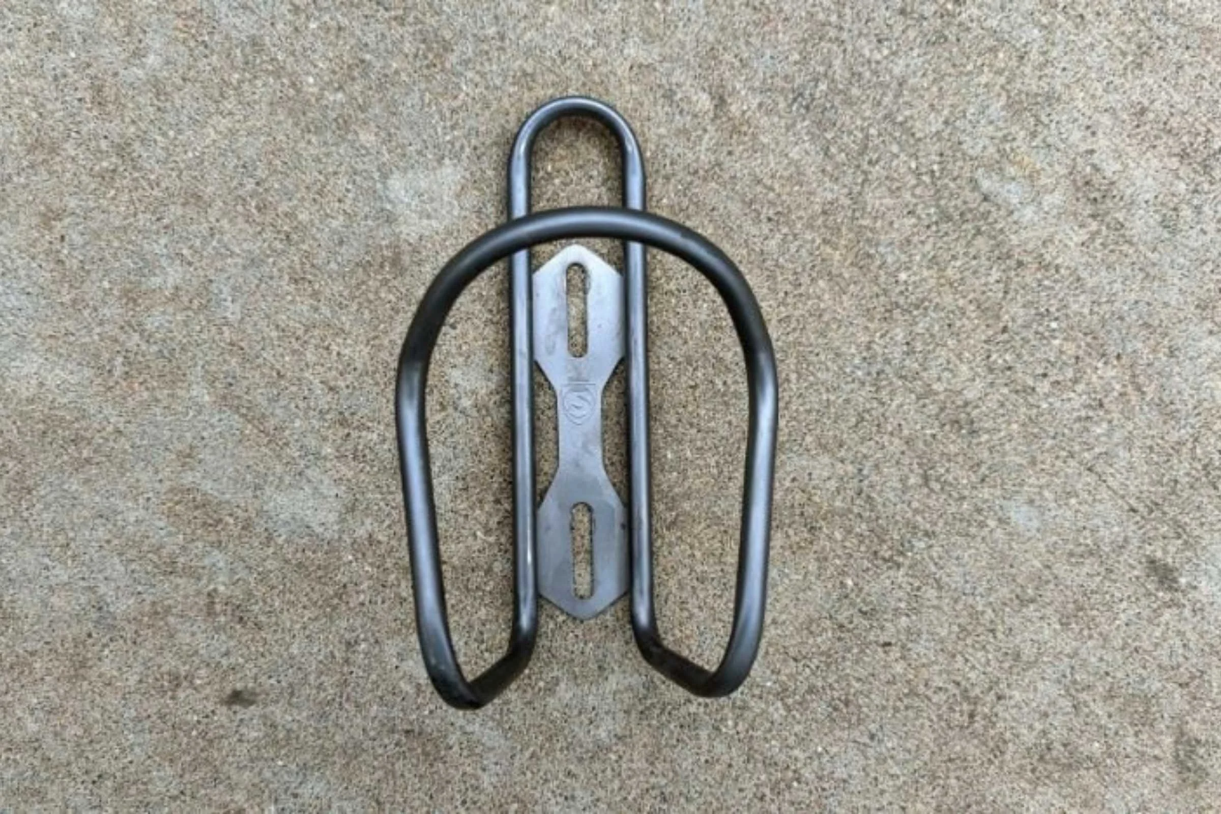 The Silca Sicuro titanium water bottle cage mounted on a bike frame.