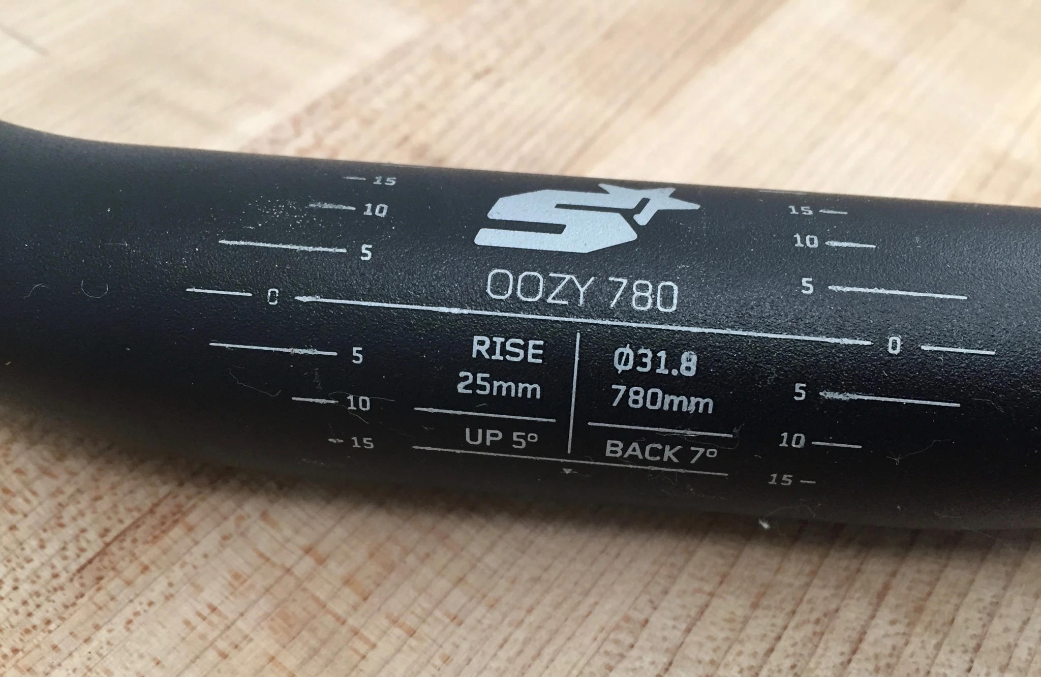 A collection of various mountain bike handlebars showing different rises and backsweep angles.