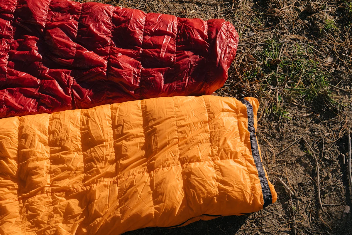 Close-up of a sewn footbox vs a zippered footbox on a backpacking quilt.