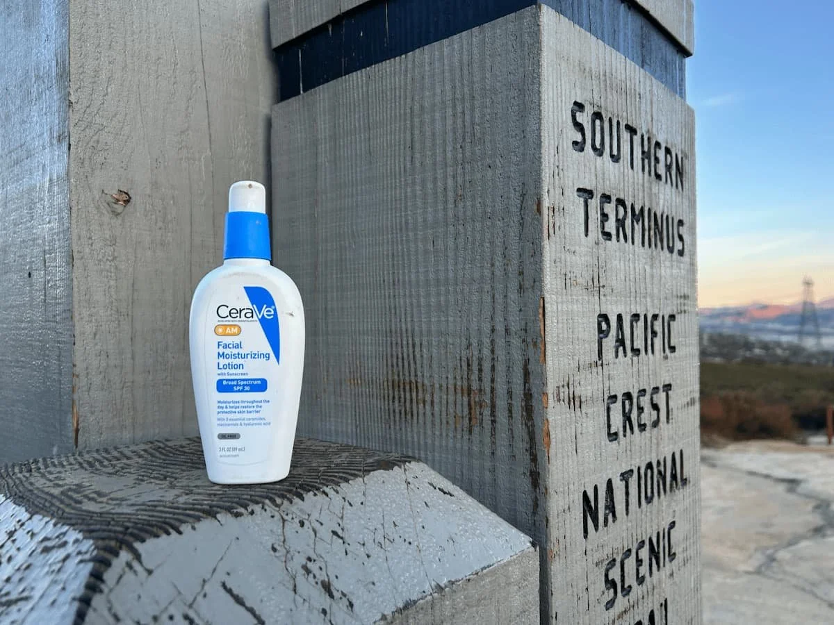 CeraVe face sunscreen being held during a backpacking trip on the PCT.