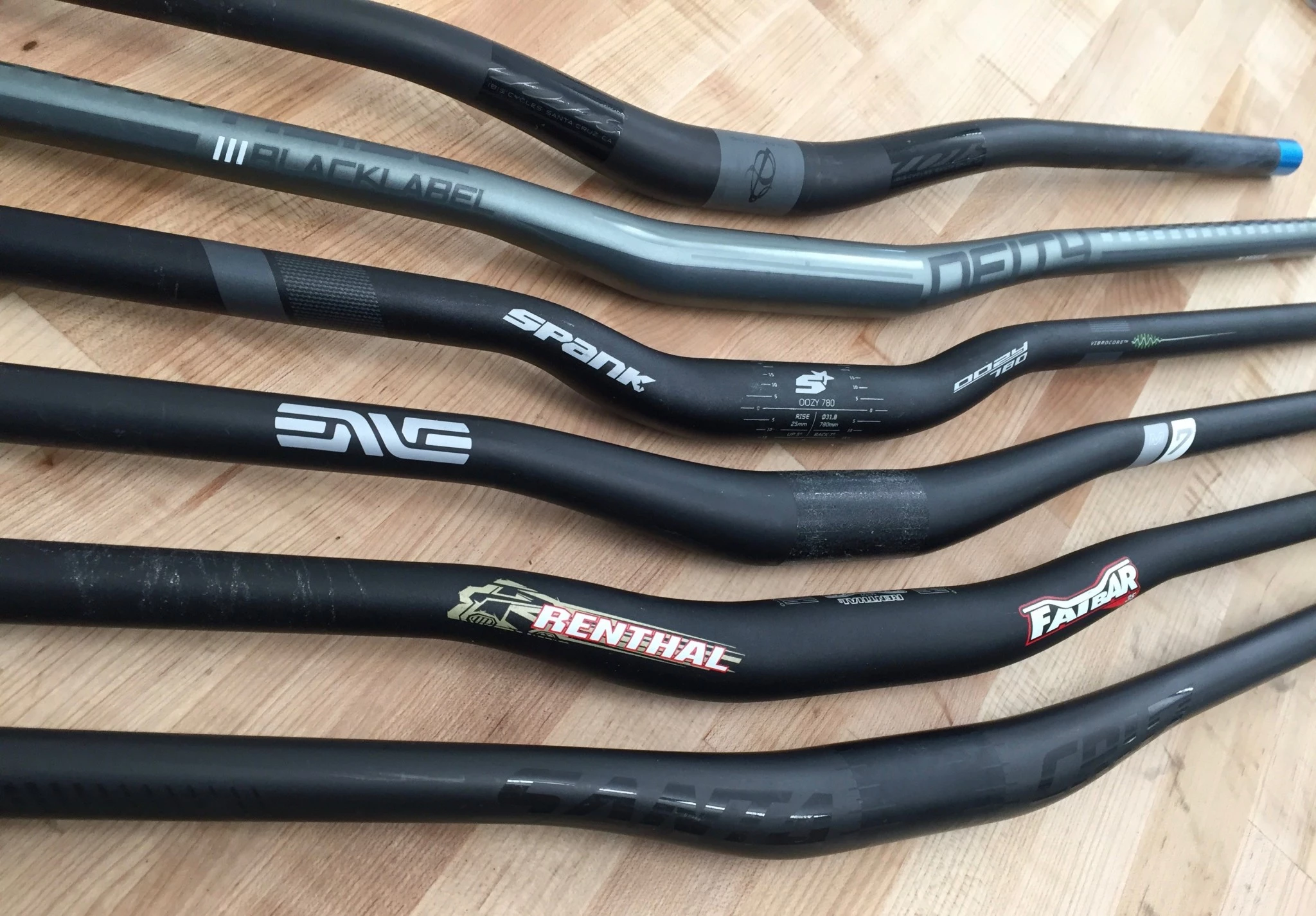 A carbon fiber handlebar and an aluminum handlebar placed side-by-side for comparison.