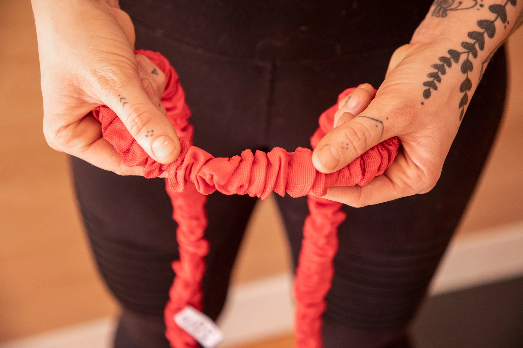A resistance band featuring a protective scrunched outer sleeve.