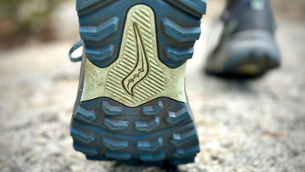A close-up view of a hiking shoe's outsole showing aggressive rubber lug patterns.