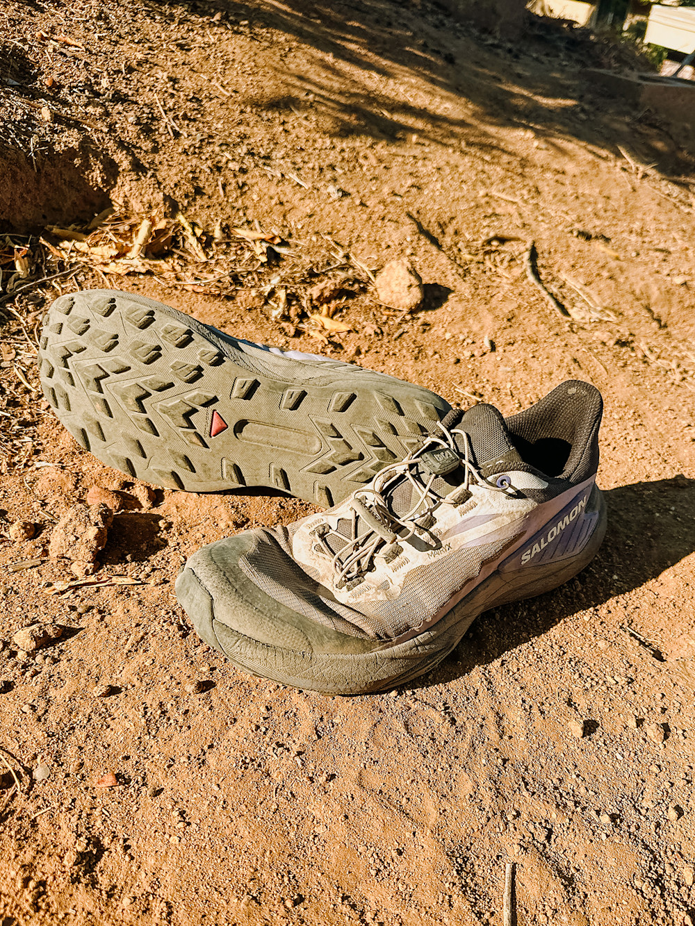 A hiker wearing trail running shoes on a coastal trail during a thru-hike.