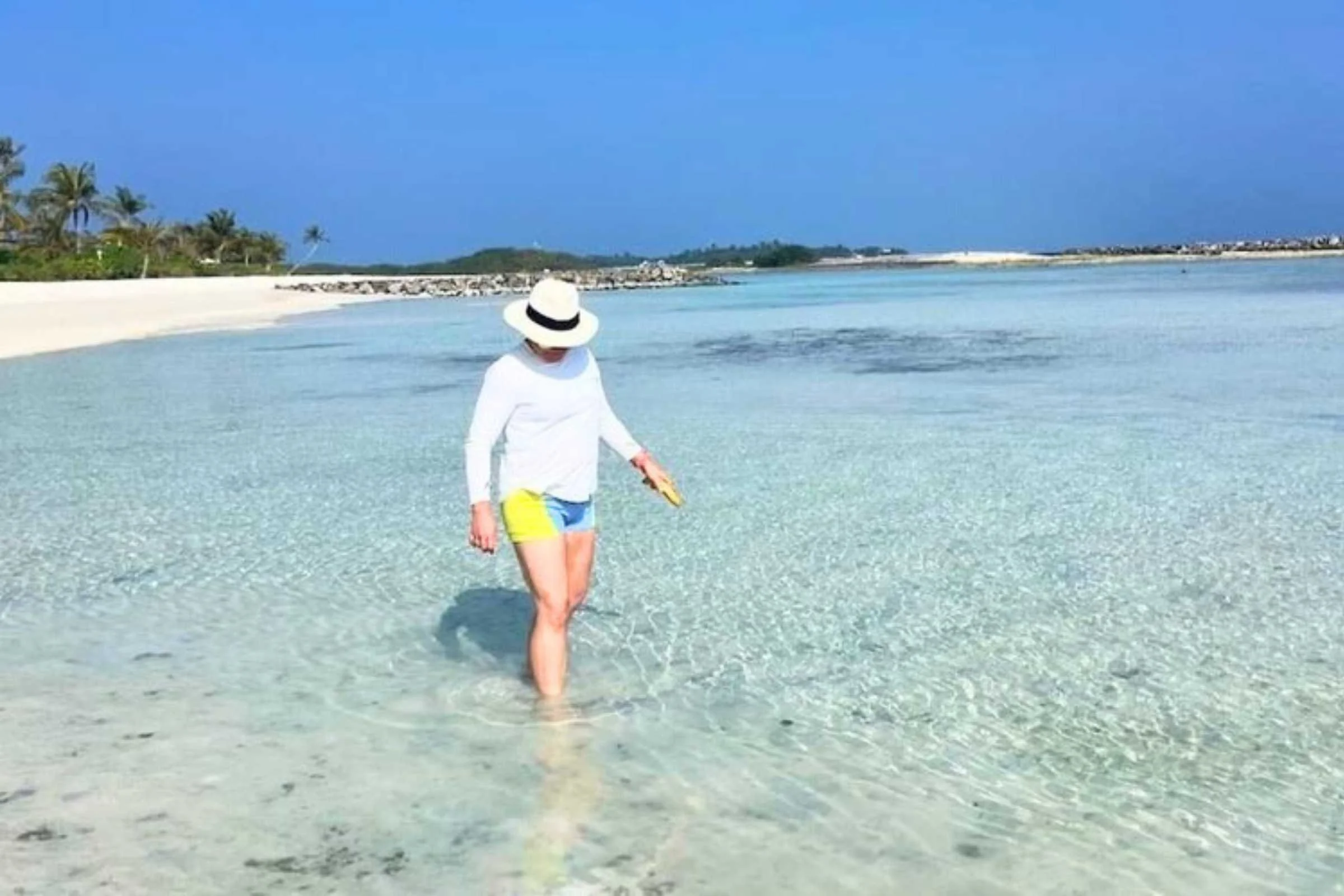 Testing reef-safe sunscreen bottles at a beach in the Maldives.