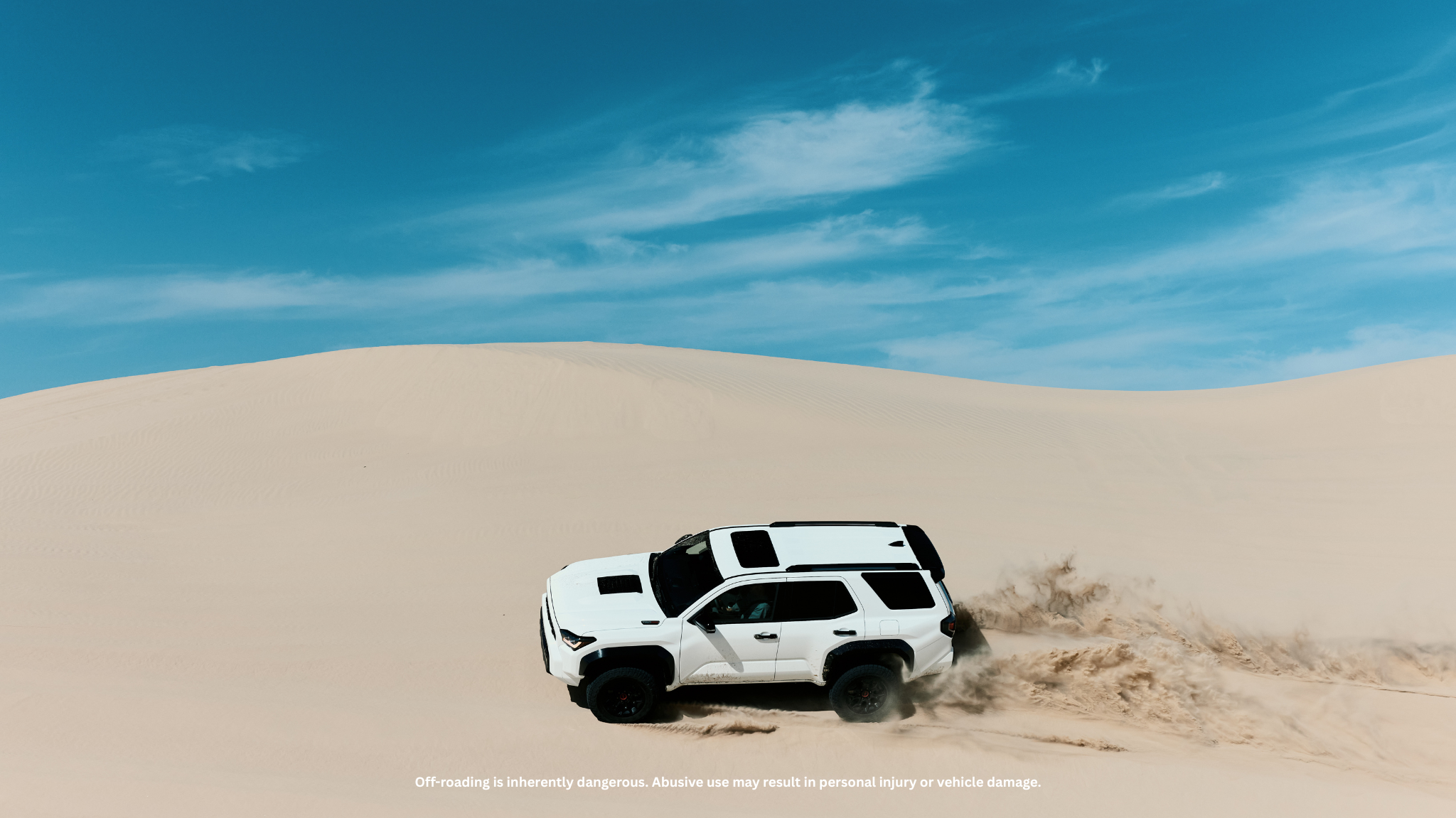 A Toyota 4Runner displaying high suspension articulation on a rocky off-road path.