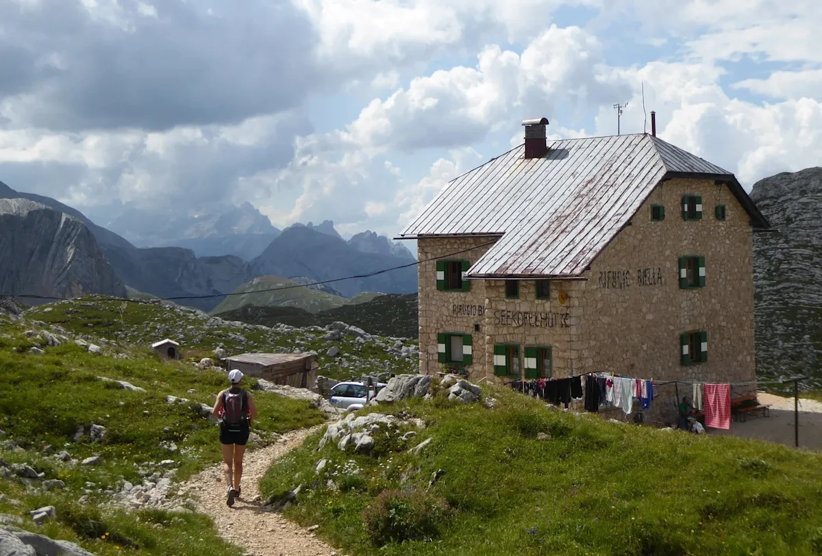Iconic jagged peaks of the Italian Dolomites visible from a mountain trail.