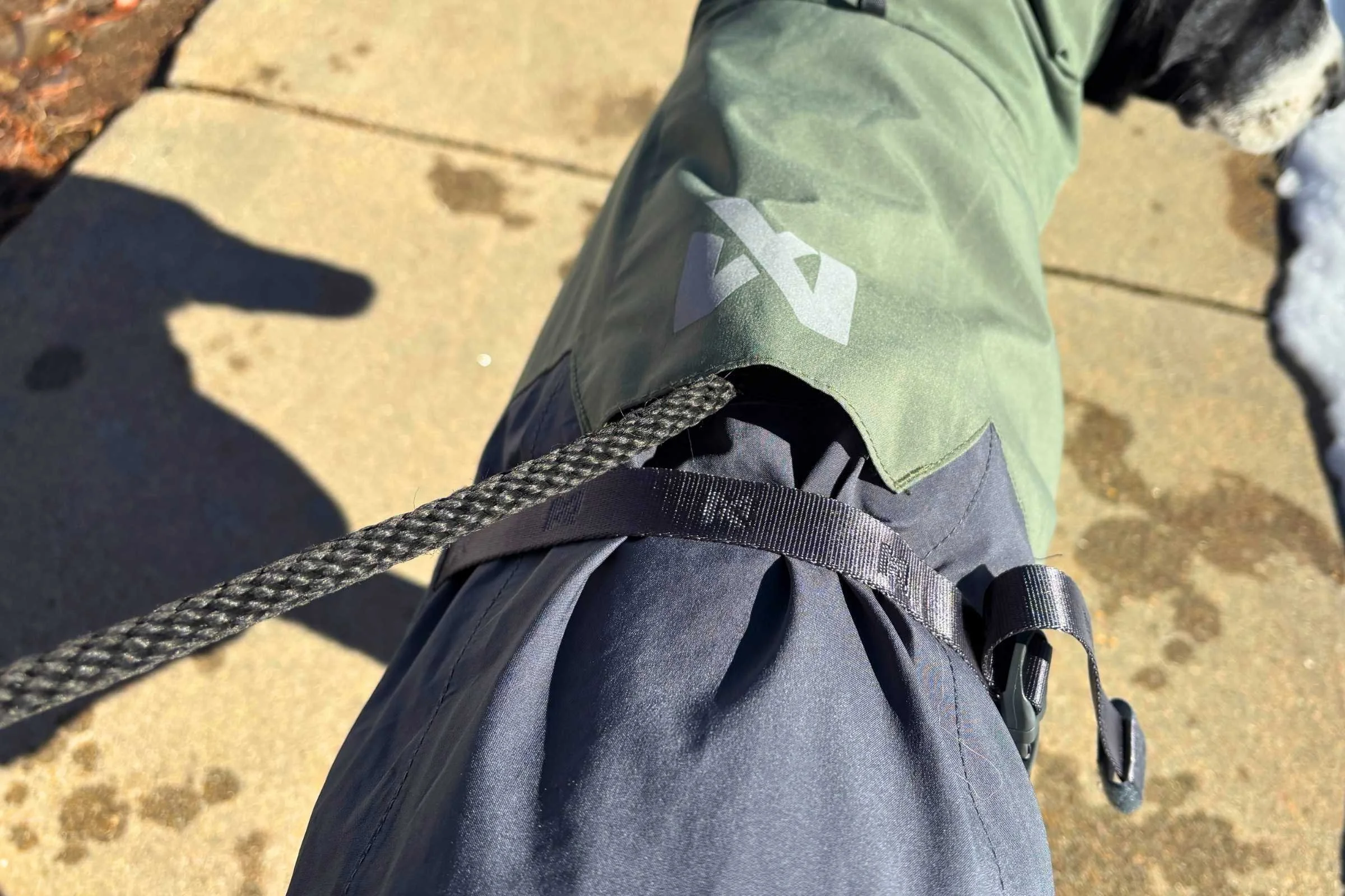 Close-up of a reinforced leash hole on the back of a dog raincoat.