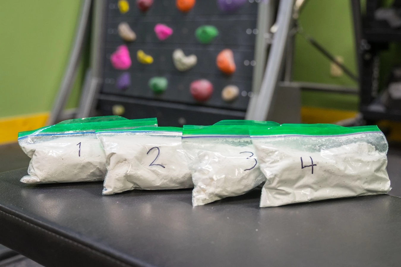 Several different brands of climbing chalk lined up for a blind performance test.