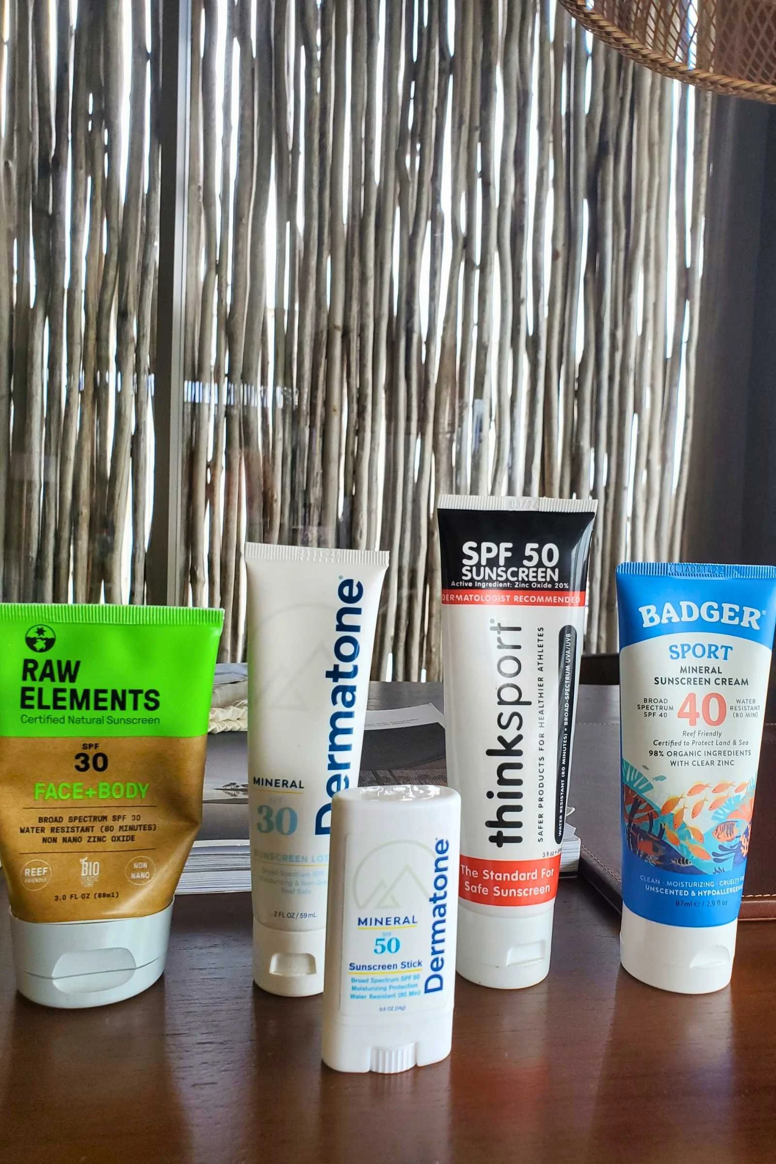 A collection of assorted reef-safe and reef-friendly sunscreen bottles for testing.
