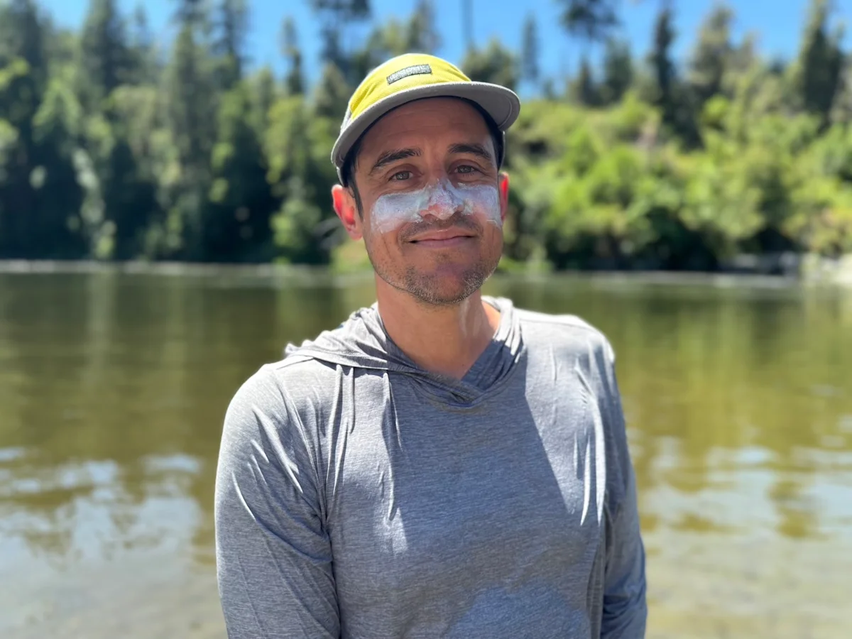 A man with visible white zinc sunscreen applied to his nose and cheeks.