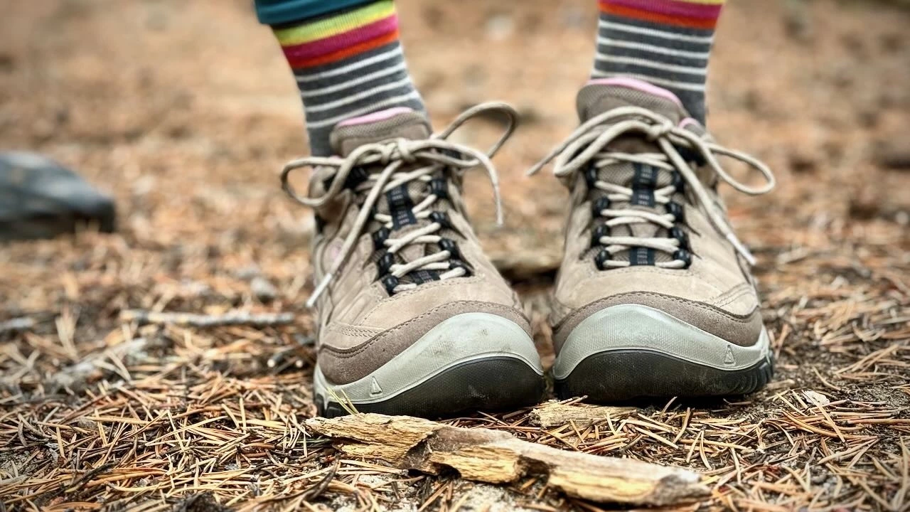 Front view of a Keen hiking shoe highlighting the reinforced rubber toe cap and wide shape.