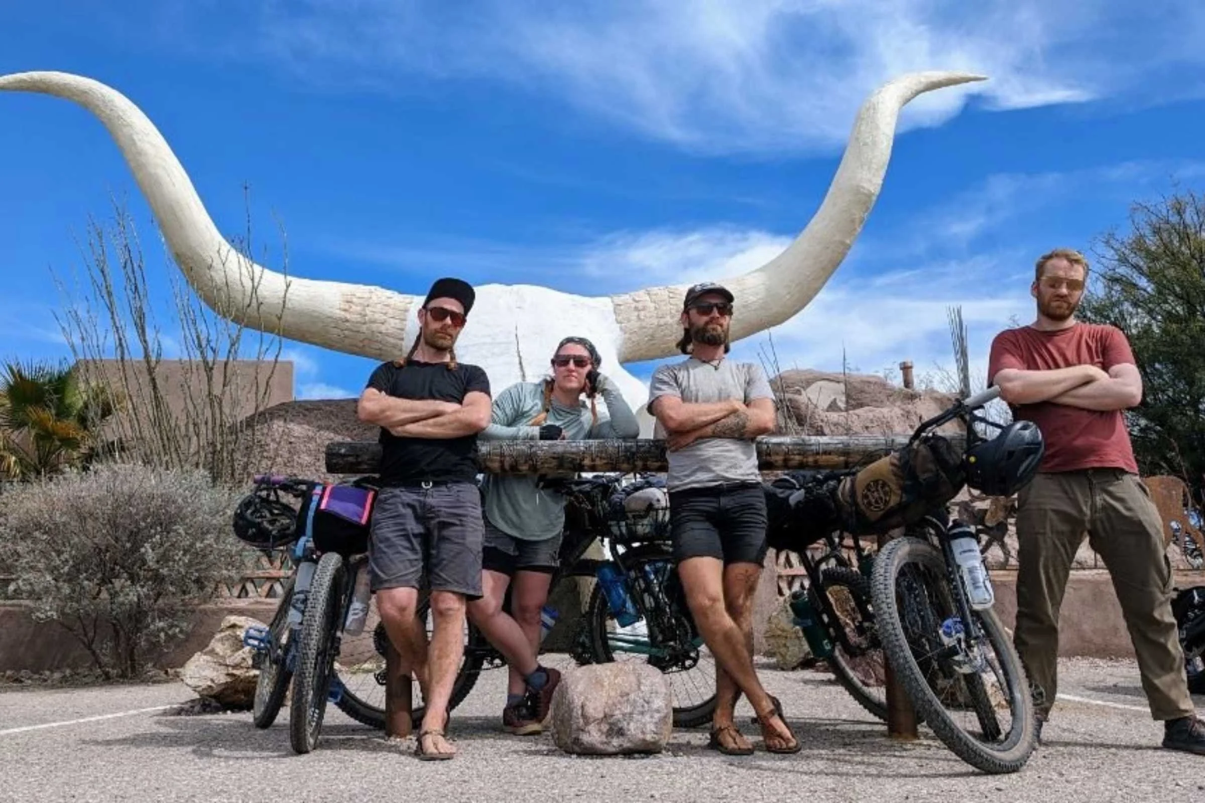 A cyclist testing water bottle cages on a gravel bike during a bikepacking trip in Arizona.