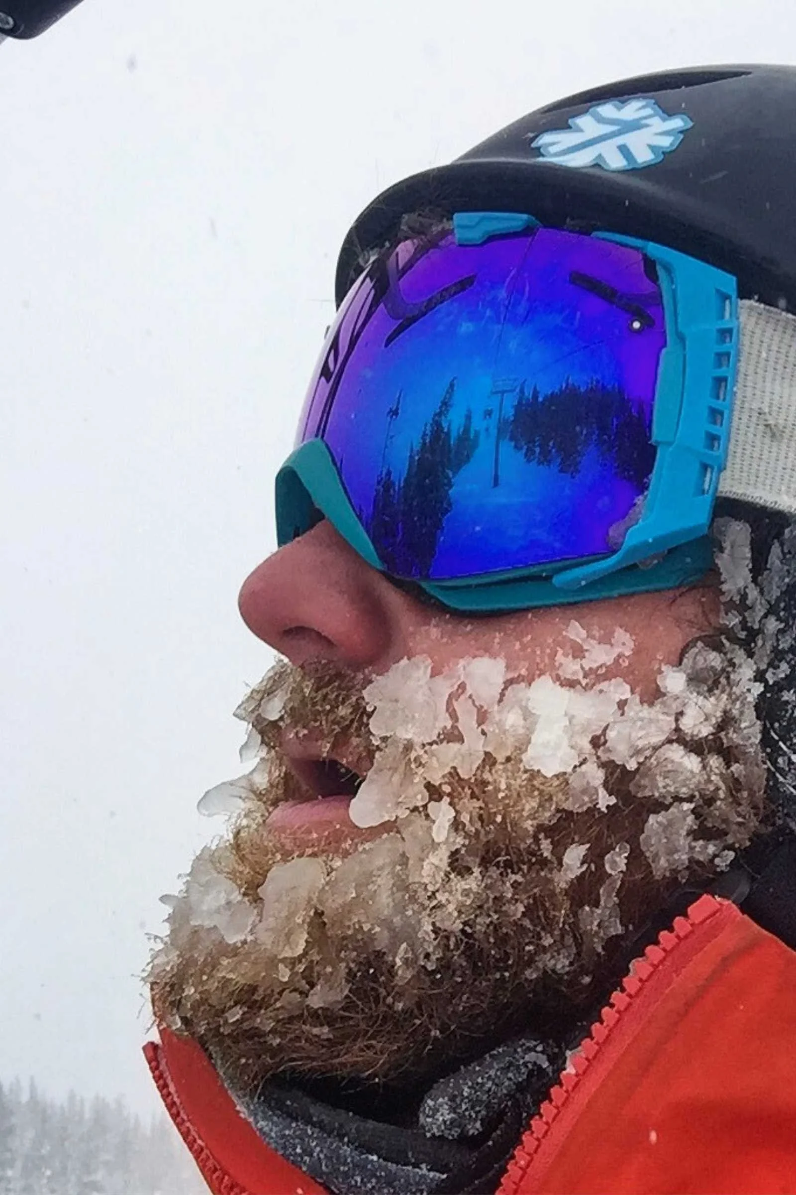 A skier wearing a well-maintained helmet after finishing a day on the slopes.